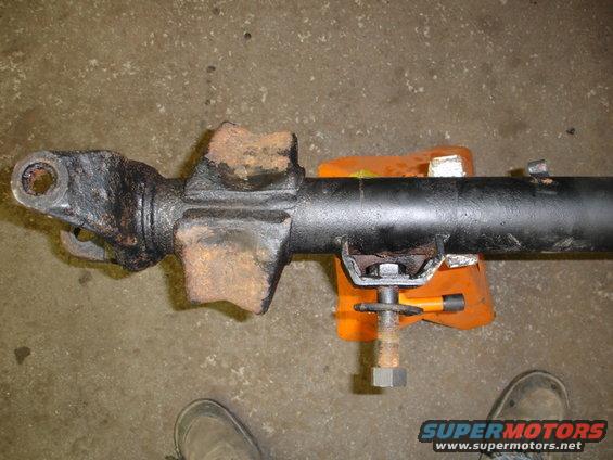 Radius arm crossmember and track bar mount held in orange vise