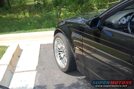 Black 2002 BMW M3 side view showing front wheel and fender vent