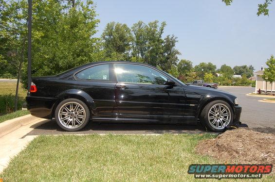Black 2002 BMW M3 coupe parked on grass and asphalt