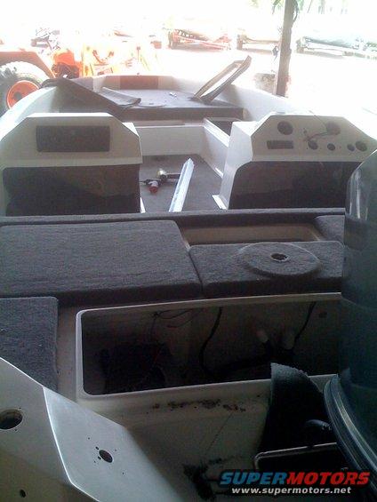 Boat interior with upholstered seats and dashboard