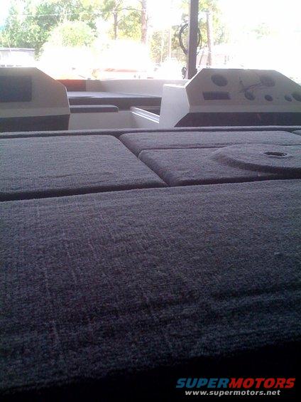 Carpeted deck and dashboard of a boat
