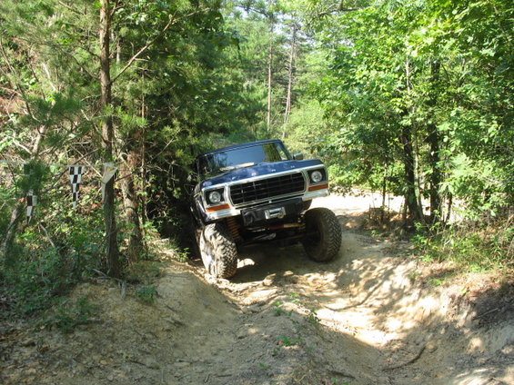 Blue 1978 Ford Bronco navigating an off-road trail