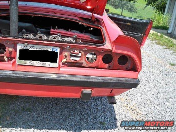 Red 1974 Pontiac Firebird rear end with trunk open, taillights removed, and Tennessee license plate