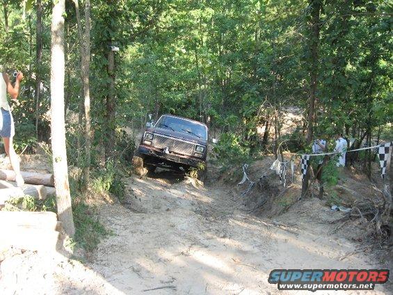 1978 Ford Bronco climbing muddy hill, 3q-front view