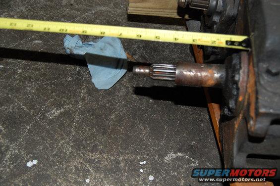 Axle shaft with splines measured by a yellow tape measure