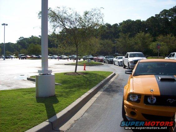 Orange and black Ford Mustang front corner, hood scoop, grille emblem visible