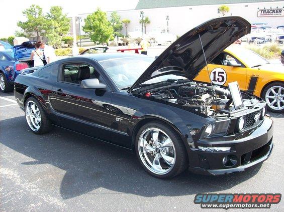 Black 2007 Ford Mustang GT, hood open, chrome wheels