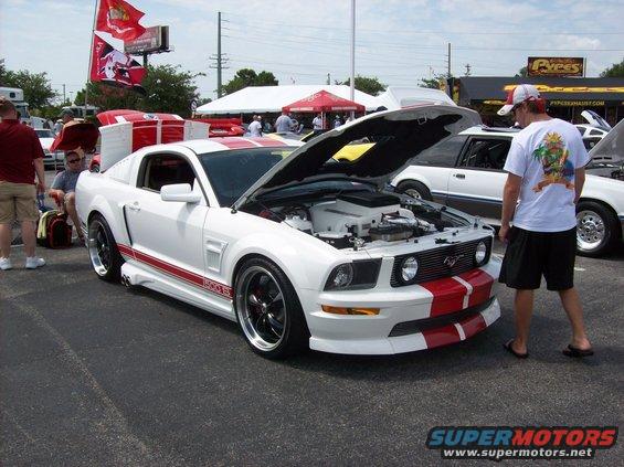 White 2007 Ford Mustang with red stripes, hood open, 3q-front view