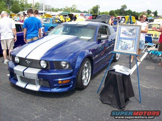Blue 2007 Ford Mustang with white racing stripes and custom hood