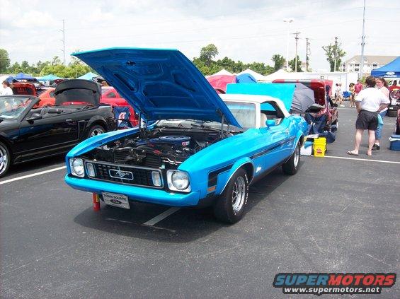 Blue 1971 Ford Mustang convertible with hood open, showing engine