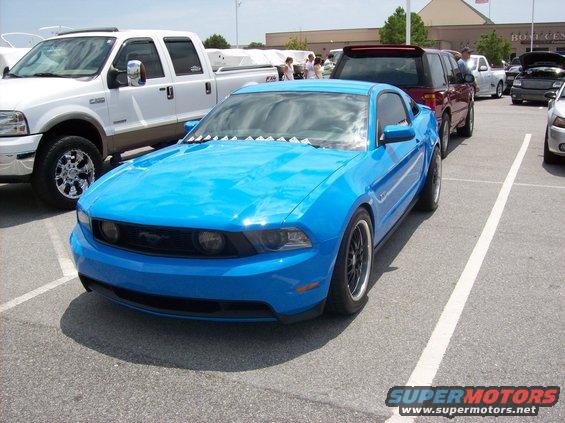Blue coupe with black wheels, front 3/4 view. 2010 model year