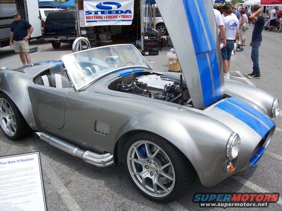 Silver Shelby Cobra replica, blue stripes, engine exposed under hood