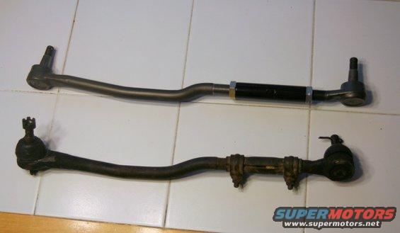 Two tie rod assemblies, one new and one old, on a tiled surface
