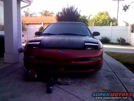 Red and black Ford Probe with pop-up headlights facing forward