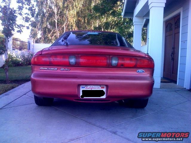 Rear view of a red 1995 Ford Probe parked in a driveway