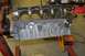 1996 Ford Bronco - A disassembled engine block is mounted on a stand in a workshop setting.