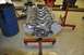 1996 Ford Bronco - Engine block on a stand in a workshop environment with a blue barrel nearby.