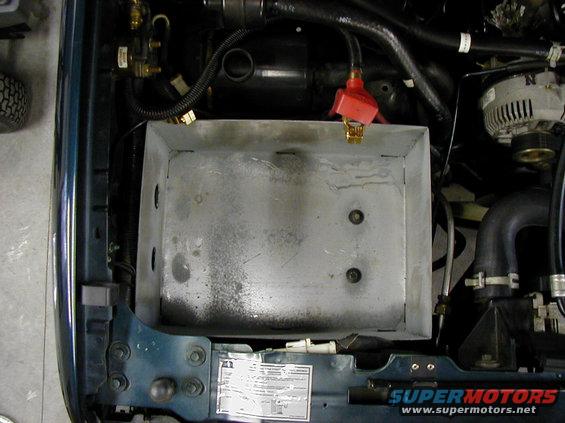 p1310020.jpg dual battery box utilizes the same space as the stock.  Only mod was to the air intake that had to be cut shorter.