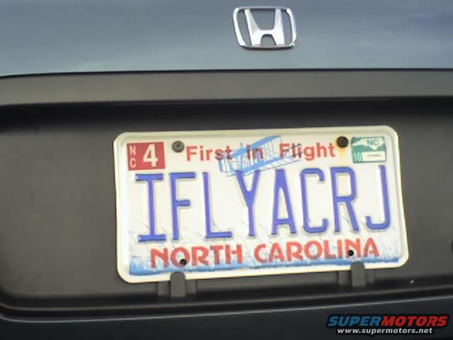 Honda emblem above North Carolina license plate reading IFLYACRJ
