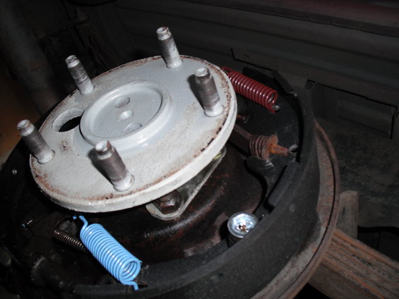 Close-up of a vehicle's drum brake assembly with new springs installed