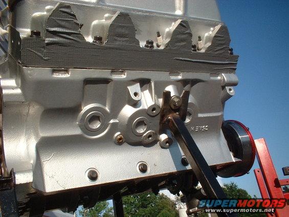 Silver engine block with black tape on top, viewed from the side