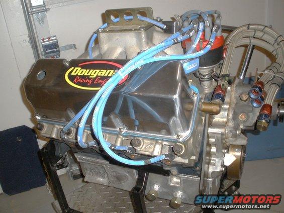 chrome valve cover with Dougan's Racing Engines sticker and blue spark plug wires