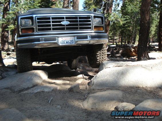 Dark Ford Bronco on rocky terrain, front view. California license plate 6BEW620 visible
