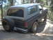 1984 Ford Bronco - Ford Bronco navigating a rocky trail with a spare tire on the back.