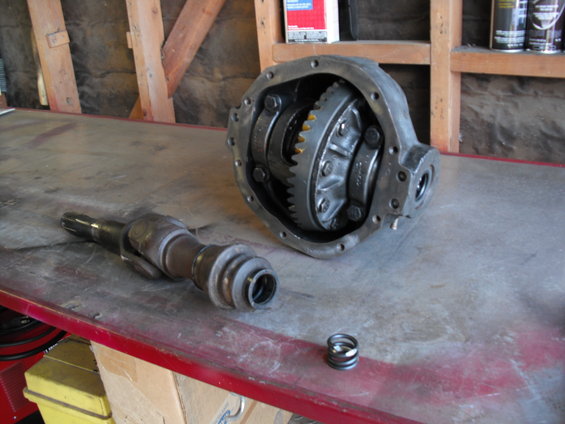 Differential housing and driveshaft components on a workbench