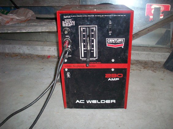 Red and black Century AC Welder with 230 AMP label and amperage selector