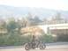 1985 Honda CMX250 Rebel - A motorcycle rider travels down a road with mountains in the background.
