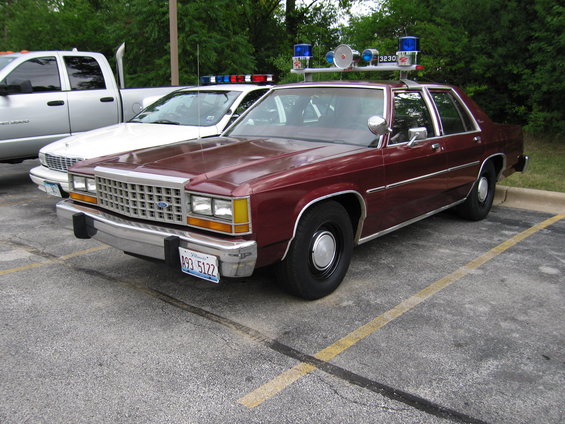 Maroon police car with light bar, 1991 Ford Crown Victoria