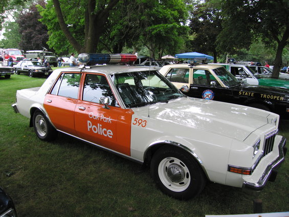 White and orange police car with "Oak Park Police" text and number 593