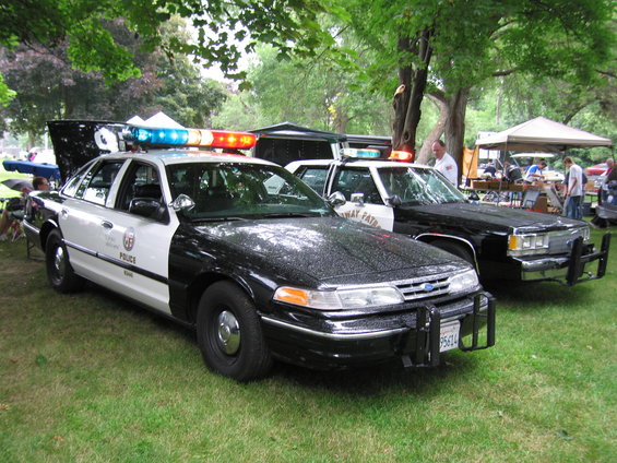 Black and white police car with light bar, 1991 Ford Crown Victoria