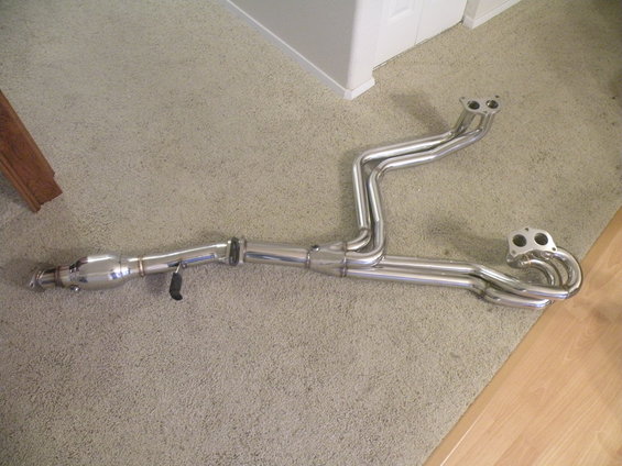 Exhaust manifold with catalytic converter and dual exhaust pipes, made of shiny metal