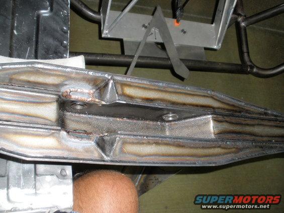 Welded metal frame part with visible bolts and heat discoloration