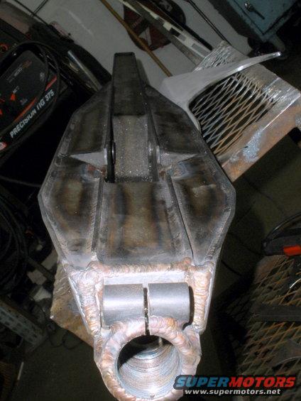 Welded metal suspension component with threaded opening and two cylindrical inserts