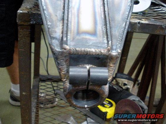 Welded metal suspension part with threaded opening and two cylindrical mounts