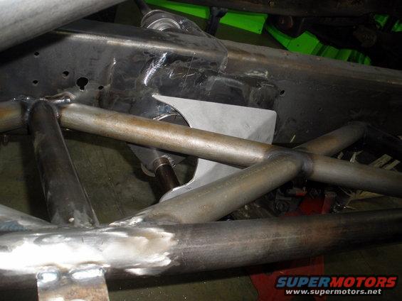 Custom suspension tubing and metal plate welded to a vehicle frame
