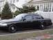 2002 Ford Crown Victoria - A black 2002 Ford Crown Victoria sedan is parked on a residential street.