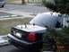 2002 Ford Crown Victoria - Rear view of a black 2002 Ford Crown Victoria, dual antennas and tinted windows.