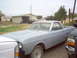 1966 Ford Ranchero - A 1966 Ford Ranchero, prepped for paint, sits in a yard with other vehicles.