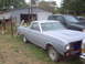 1966 Ford Ranchero - This 1966 Ford Ranchero is in primer and parked outdoors next to a dark SUV and a garage.
