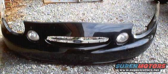 Black front bumper with chrome grille and headlights, Supermotors.net logo visible