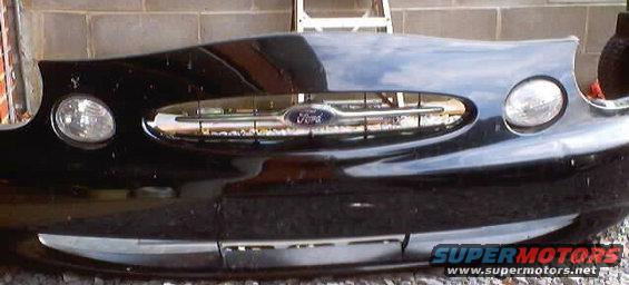 Black 1999 Ford Taurus front bumper with chrome grille and headlights