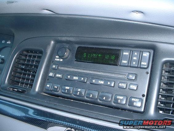 Car interior dashboard showing radio display with time 12:18 and air vents