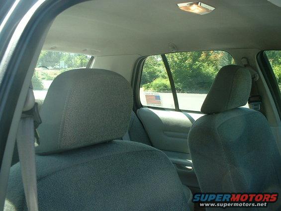 Interior shot of car seats and windows. American flag sticker on rear window