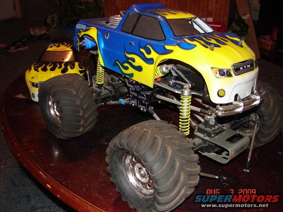 RC monster truck, 3q-front view, blue and yellow flames