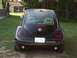1999 Volkswagen Beetle - Rear view of a black 1999 Volkswagen Beetle parked outdoors.