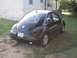 1999 Volkswagen Beetle - Rear view of a black Volkswagen Beetle with a license plate visible.